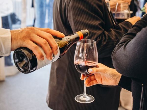 Servicio de vino tinto español durante un evento corporativo organizado por Grupo Tartar
